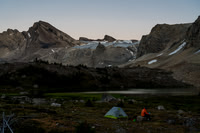 Preparing to leave camp at first light with Deluc rising in the distance at left.