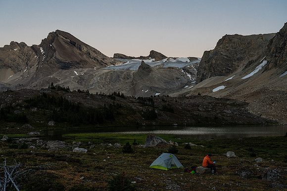 Preparing to leave camp at first light with Deluc rising in the distance at left.