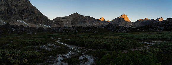 Looking back from the boulder field as the sun rises on peaks behind us.