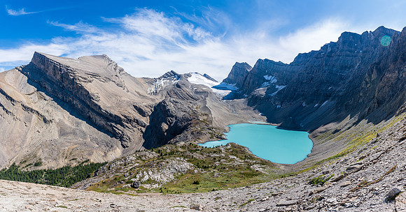 A stunning lake awaits at the escape from the traverse! Dip Slope rising at left.