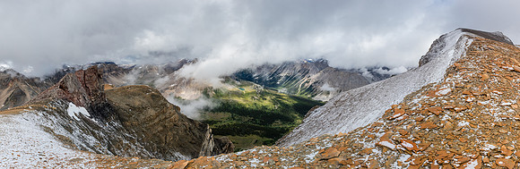 On the summit ridge with the summit at right and the Pipestone River far below.