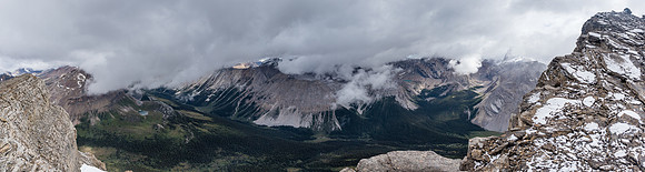 Dramatic views over the Pipestone River towards Cataract Peak rising in clouds at right.