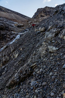 Descending steep rubble slopes to exit the headwall.