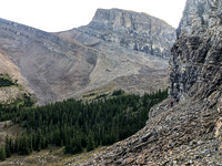 Traversing a goat path along cliffs to the west to avoid wet bushwhacking.