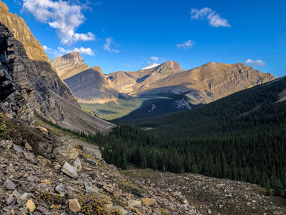 Traversing a goat path along cliffs to the west to avoid wet bushwhacking.