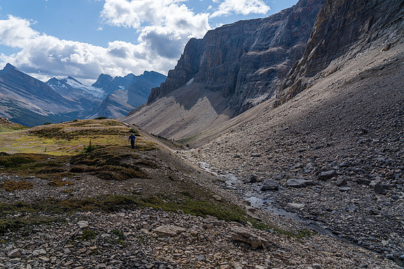 Dip Slope at left, Deluc at center as Cornelius hikes into the south hanging valley of Mount Harris.