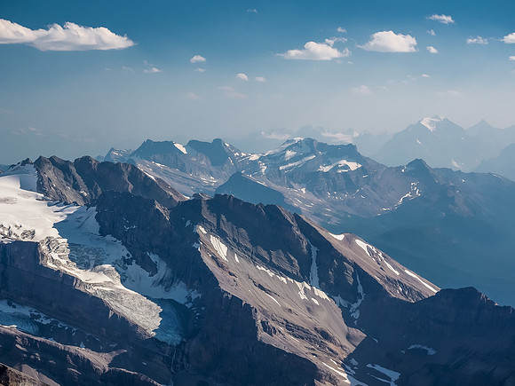 Looking over Cyclone Mountain (L) towards Richardson, Pika and Ptarmigan in the Skoki area and Mount Temple in the smoky haze at distant right.