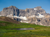 The small tarn that is the start of Mosquito Creek with the impressive NE face of Noseeum Mountain rising beyond.