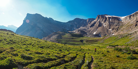 Phil works his way up the heavily braided trail to NMP with Minnow Peak looming over Fish Lakes at left.