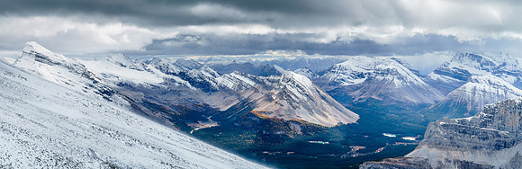 A wild scene of wind, snow, rock, larches and water. The lower Red Deer Lakes catch some sun as we descend.