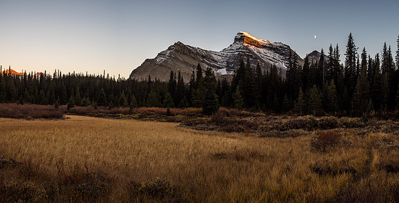 Mount Douglas catches the last few rays of sunshine with the moon rising to it's right.