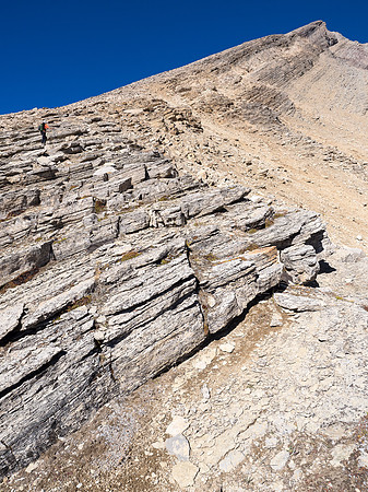 Ledges and fairly 'solid' scree assist in an efficient ascent of the mountain's south aspect. The false summit looms above us here.