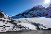Back at the snow coach staging area. You can barely spot someone skiing beside the snow coach road on the left.