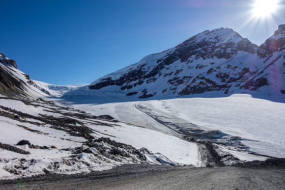 Back at the snow coach staging area. You can barely spot someone skiing beside the snow coach road on the left.