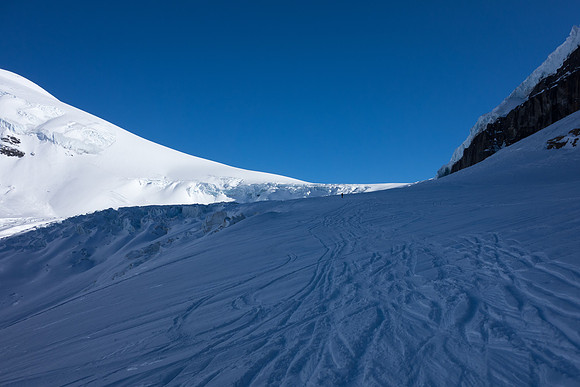 Looking back at Anton skiing under the Snow Dome seracs.