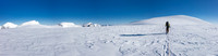 TJ skis to the summit block of Kitchener with South, North Twin and the Stuts on the left.