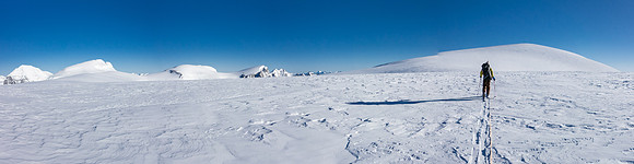 TJ skis to the summit block of Kitchener with South, North Twin and the Stuts on the left.