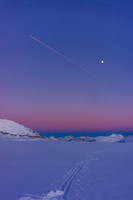 Our approach tracks with the moon and a plane catching the setting sun.