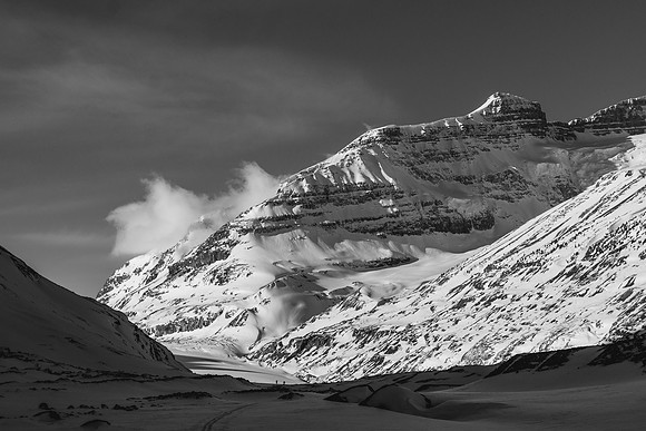 So and Ferenc come off the Saskatchewan Glacier with an outlier of Mount Andromeda towering above them.