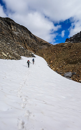 Using snow patches to gain height to the headwall guarding Iceberg Lake.