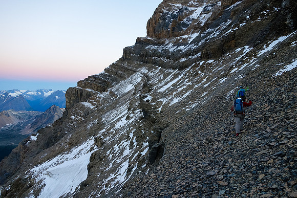 Traversing easy scree from the col before heading up the SW face.