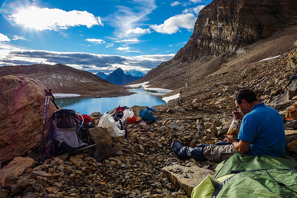 Eric eats supper at our delightful bivy. Iceberg Lake is about 40 feet below us here.