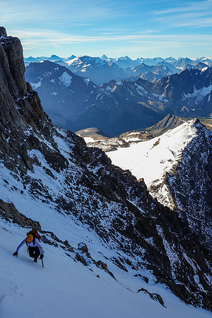 Ferenc crosses a steep snow gully (we climbed it from below-right) to join up with our ascent party.