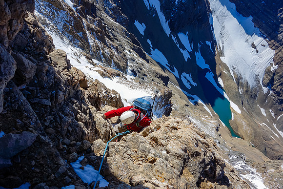 Eric comes up the first pitch (5.4) which is also the rap route. Iceberg Lake and our bivy spot far below him now.