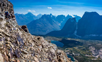 Liam on some loose terrain - you can see the two Catacombs Lakes far beneath now and Fortress Mountain on the right.
