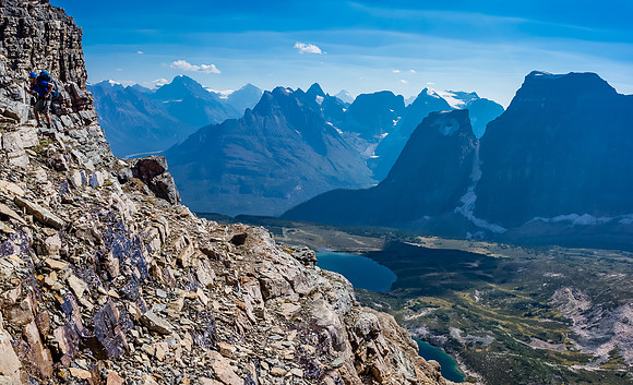 Liam on some loose terrain - you can see the two Catacombs Lakes far beneath now and Fortress Mountain on the right.