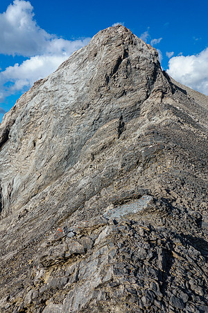 Thankfully the difficult upper SW ridge can be bypassed on scree at climber's right.