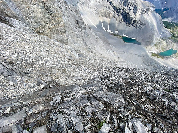Descending the steep break in the summit cliffs to the scree bench.