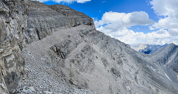The only break in the summit cliffs is just ahead trending left of the scree ledge.