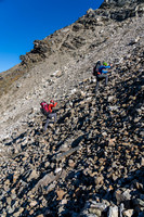Ascending scree and boulders up north slopes of the Quartzite Col.