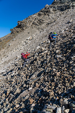 Ascending scree and boulders up north slopes of the Quartzite Col.