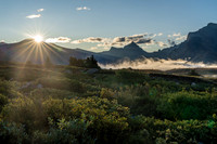 The sun rises over Clearwater Pass in this view to Dip Slope Mountain from Devon Lakes.