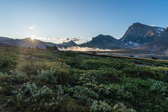 The sun rises over Clearwater Pass in this view to Dip Slope Mountain from Devon Lakes.