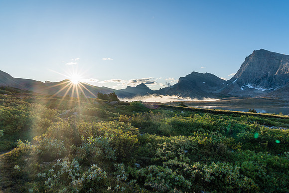 The sun rises over Clearwater Pass in this view to Dip Slope Mountain from Devon Lakes.