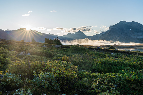 The sun rises over Clearwater Pass in this view to Dip Slope Mountain from Devon Lakes.