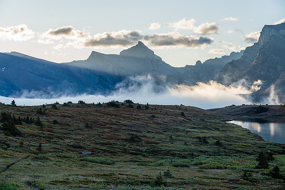 The sun rises over Clearwater Pass in this view to Dip Slope Mountain from Devon Lakes.
