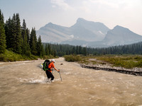 Phil recrosses a very swollen and very fast Drummond Creek with Mount Douglas looming in the background.