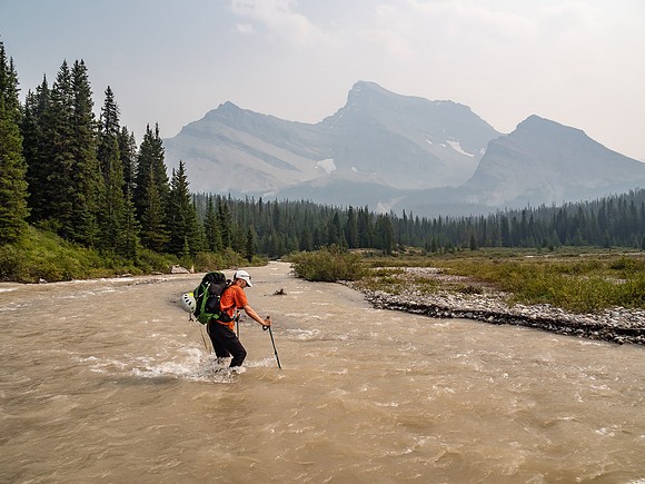 Phil recrosses a very swollen and very fast Drummond Creek with Mount Douglas looming in the background.