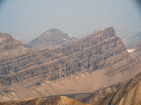 Deluc (Three Brothers) Peak is also over 10,400 feet high. Mount Willingdon buried in the smoke somewhere at distant right.