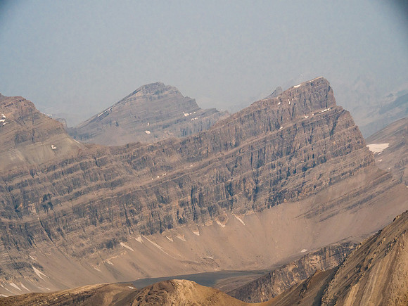 Deluc (Three Brothers) Peak is also over 10,400 feet high. Mount Willingdon buried in the smoke somewhere at distant right.
