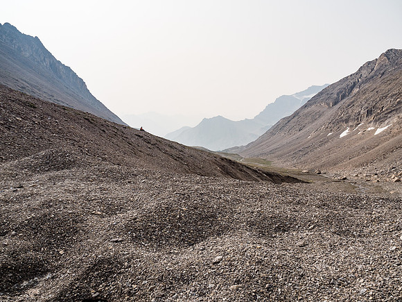 Phil empties scree from his shoes as we exit the bowl back to alpine meadows.