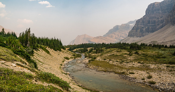 Looking downstream from near the lake and along the impressive eastern walls of Mount Drummond - we'll bivy at right here, across the stream.
