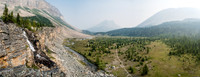 The Skoki Lakes trail snakes across the flats towards a barely visible Skoki Mountain and past Fossil Mountain on the right.