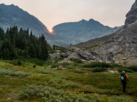 Phil leaves our bivy as the sun rises over the Lychnis Col.