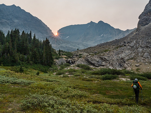 Phil leaves our bivy as the sun rises over the Lychnis Col.