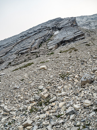 Looking up another descent line I noticed on ascent - this one would have worked well too - past the dark slabs down a steep scree gully at right.